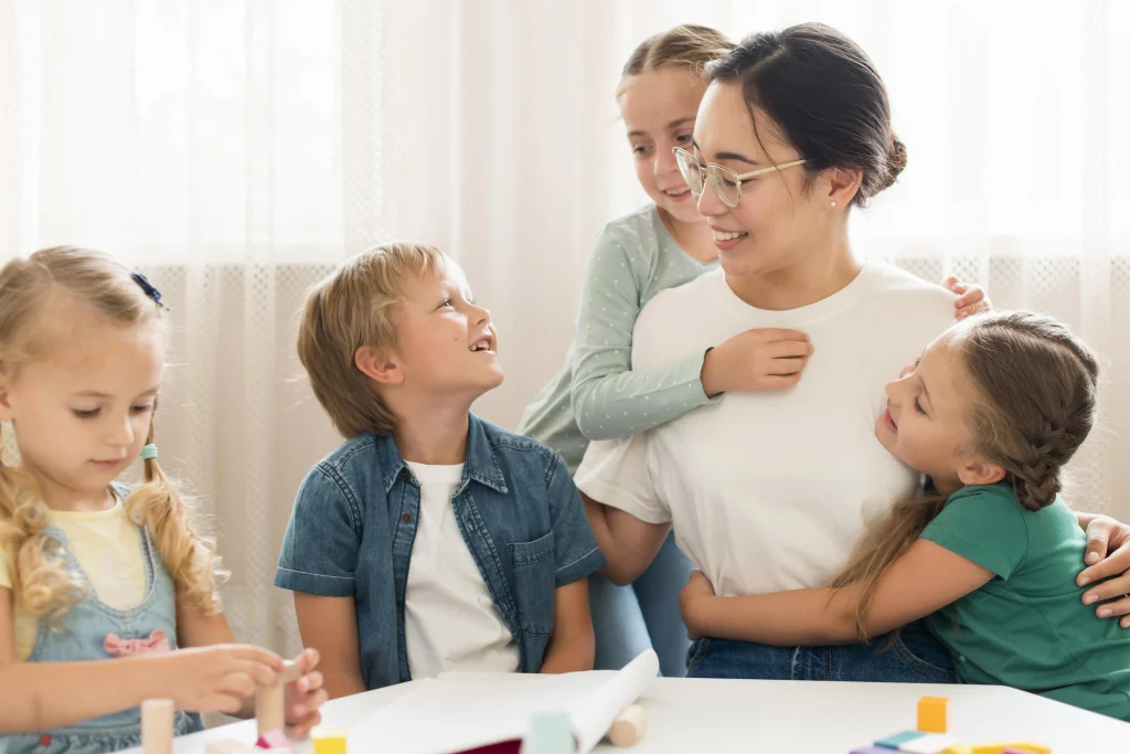 front-view-kids-hugging-their-teacher-1612510391